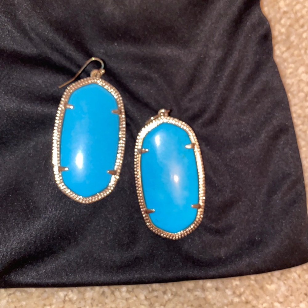 blue stone ks earrings encased in gold